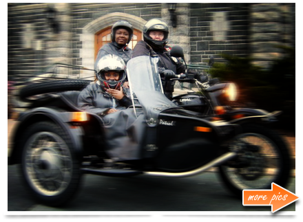Two riders on a sidecar motorcycle